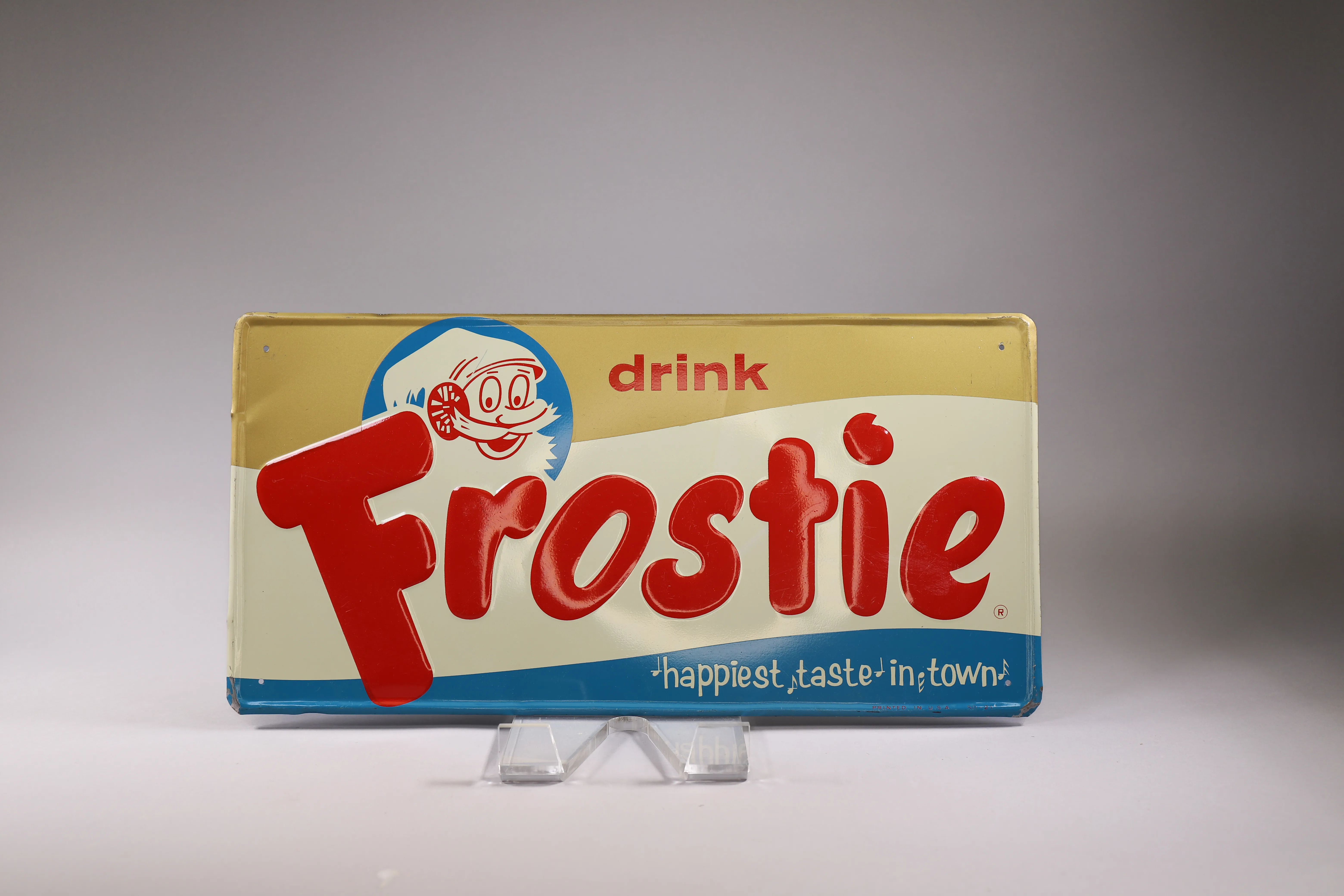 Vintage Frostie soda sign displayed as a distinctive estate sale collectible.