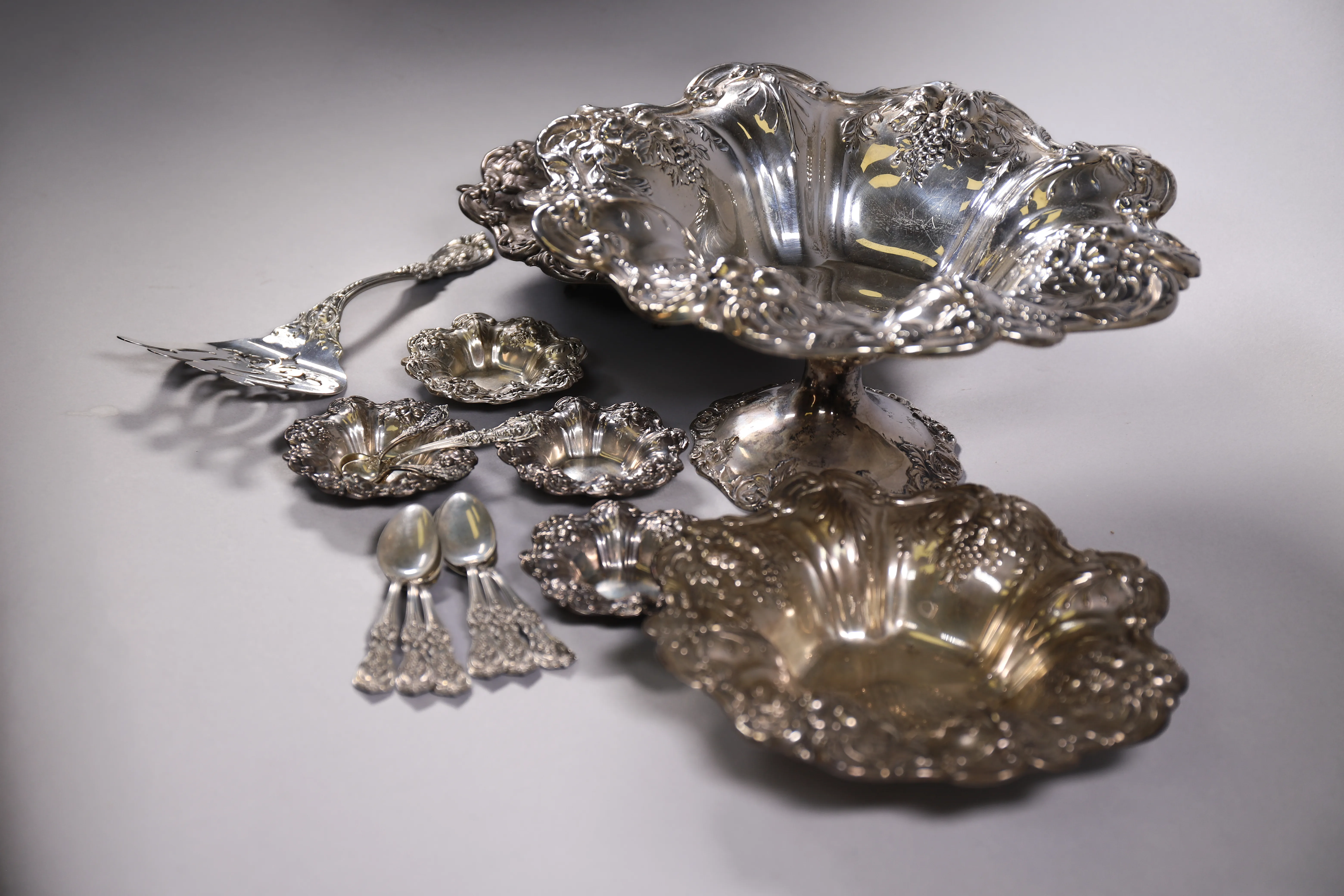 Silver bowls and serving pieces grouped as estate sale finds.