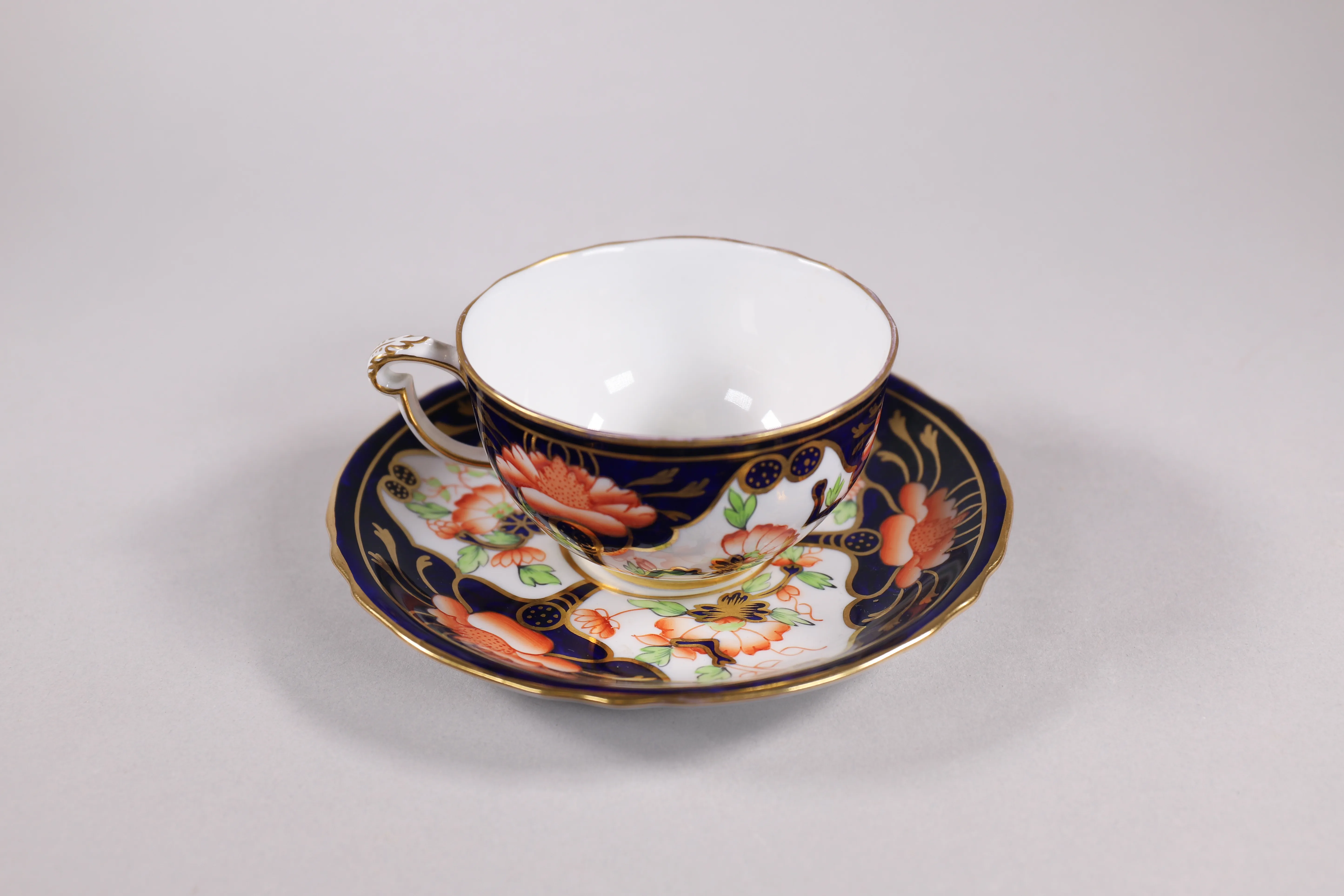 Patterned china teacup and saucer prepared for estate sale presentation.