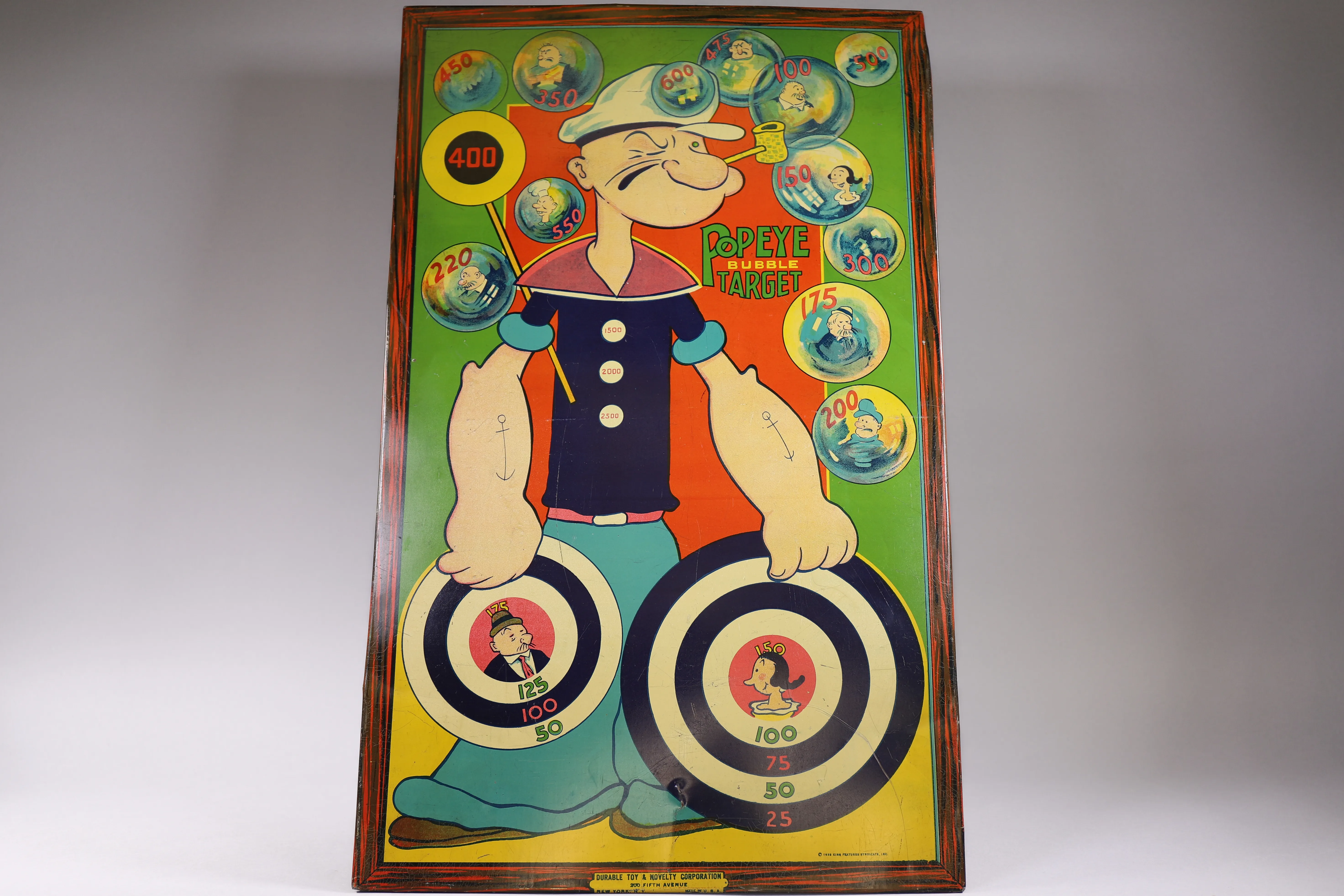 Framed vintage Popeye target board photographed as a collectible estate sale find.